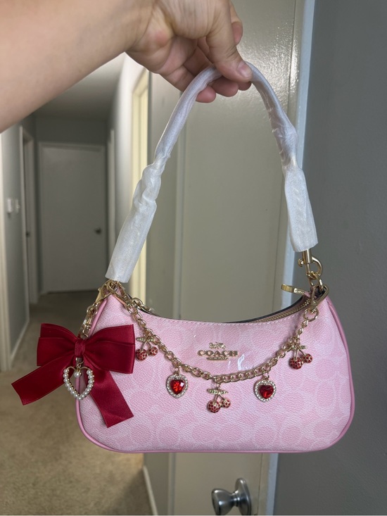 Coach Handbags - Coach Pink Shoulder Bag with Red Charm Bow